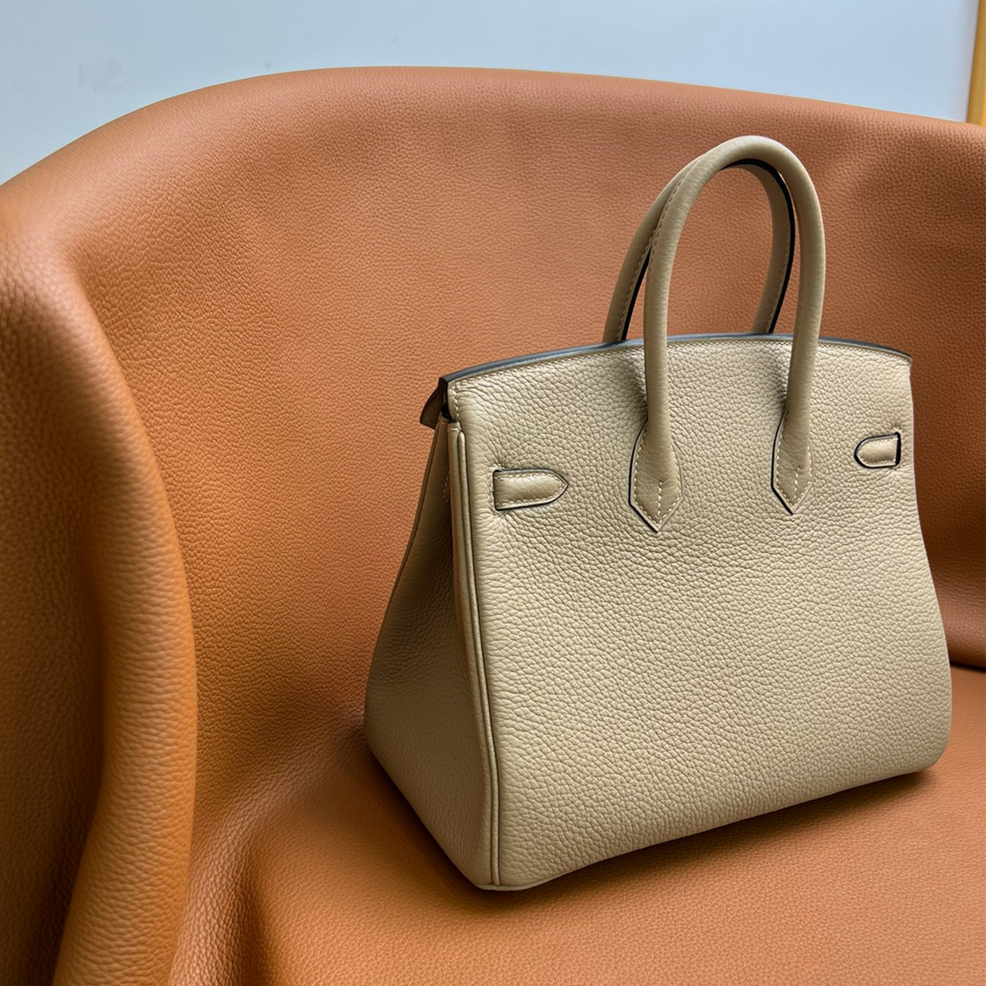 Trench Grey Compact Structured Top Handle Handbag With Polished Golden Twist Lock And Textured Grain Exterior