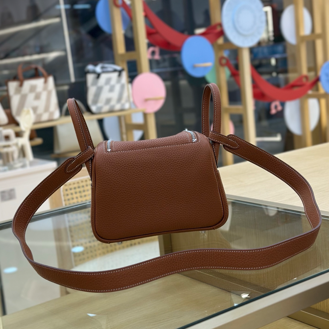 Rich Golden Brown Mini Rounded Handheld Bag With Pebbled Grain Surface, Silvery Twist Hardware And Wide Matching Shoulder Strap