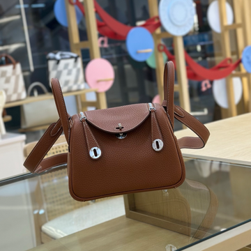 Rich Golden Brown Mini Rounded Handheld Bag With Pebbled Grain Surface, Silvery Twist Hardware And Wide Matching Shoulder Strap